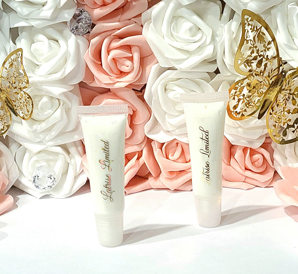 2 white colored body butter in a pocket sized tube. There is a gold label that says Latrise Limited. There is a beautiful background with pink and white roses ad well as gold butterflies. 